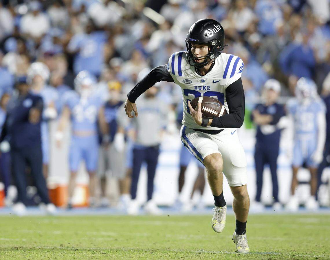 Duke’s Todd Pelino runs the ball after faking a field goal attempt during the second half of the Blue Devils’ 32-25 victory over North Carolina on Saturday, Nov. 22, 2025, at Kenan Stadium in Chapel Hill, N.C.