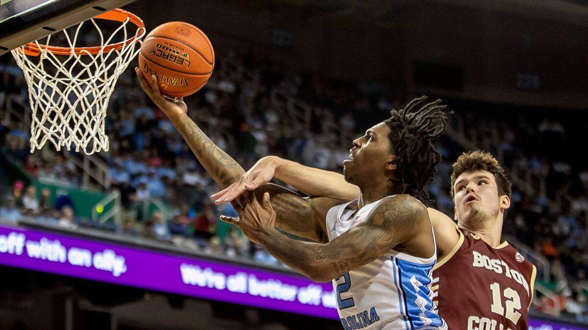 North Carolina’s Caleb Love (2) breaks to the basket against Boston College’s Quinten Post (12) during the second half in the second round of the ACC Tournament on Wednesday, March 8, 2023 at the Greensboro Coliseum in Greensboro, N.C. Love lead all scores with 22 points in the Tar Heels’ 85-61 victory.