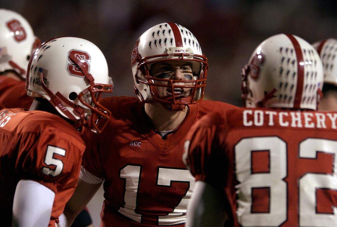 NC State’s Philip Rivers talks with wide receivers Sterling Hicks (5) and Jerricho Cotchery (82) during the Wolfpack’s game in November 2002.