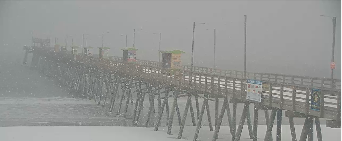 Snow accumulates on the beach and on Bogue Inlet Pier at Emerald Isle Saturday, Jan. 31, 2026. A winter storm was expected to bring up to a foot of snow to a region of North Carolina from Carteret County to the Virginia border.