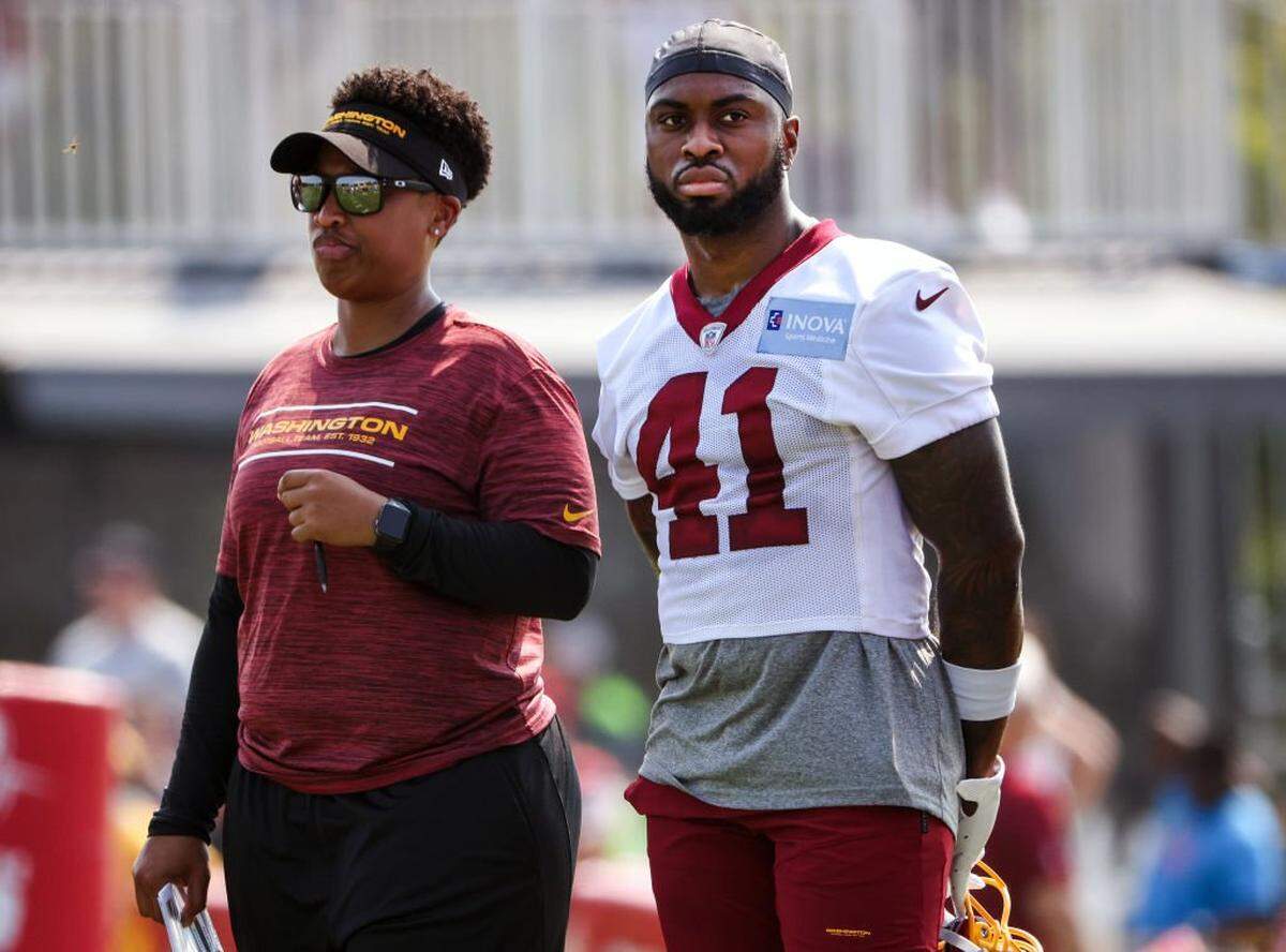 RICHMOND, VIRGINIA - JULY 28: Assistant Running Back Coach Jennifer King stands with J.D. McKissic #41 of the Washington Football Team during the Washington Football Team training camp on July 28, 2021 in Richmond, Virginia. (Photo by Kevin Dietsch/Getty Images)