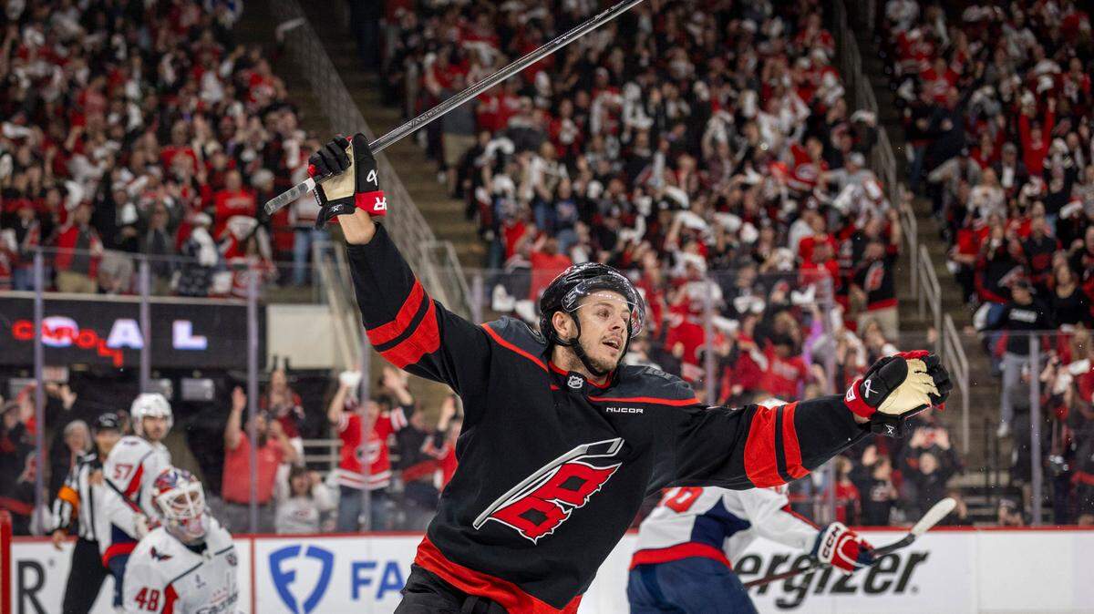 Carolina Hurricanes center Jesperi Kotkaniemi (82) reacts after a goal by teammate Shaye Gostisbehere (04) in the first period, to take a 1-0 lead against the Washington Capitals during Game 4 of their series on Monday, May 12, 2025 at Lenovo Center in Raleigh, N.C.