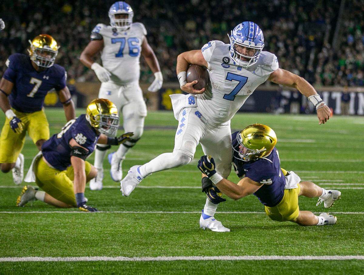 Notre Dame’s Jack Kiser (24) works to stop North Carolina quarterback Sam Howell (7) at the goal line in the second quarter on Saturday, October 30, 2021 in South Bend, Ind. Howell scored, but the play was nullified due to a holding penalty by North Carolina.