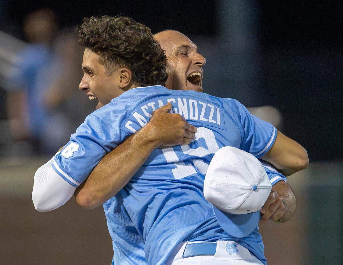North Carolina coach Scott Forbes embraces infielder Johnny Castagnozzi (19) as they celebrate their 4-3 victory over LSU, clinching their NCAA Regional on Monday, June 3, 2024 at Boshamer Stadium in Chapel Hill, N.C.