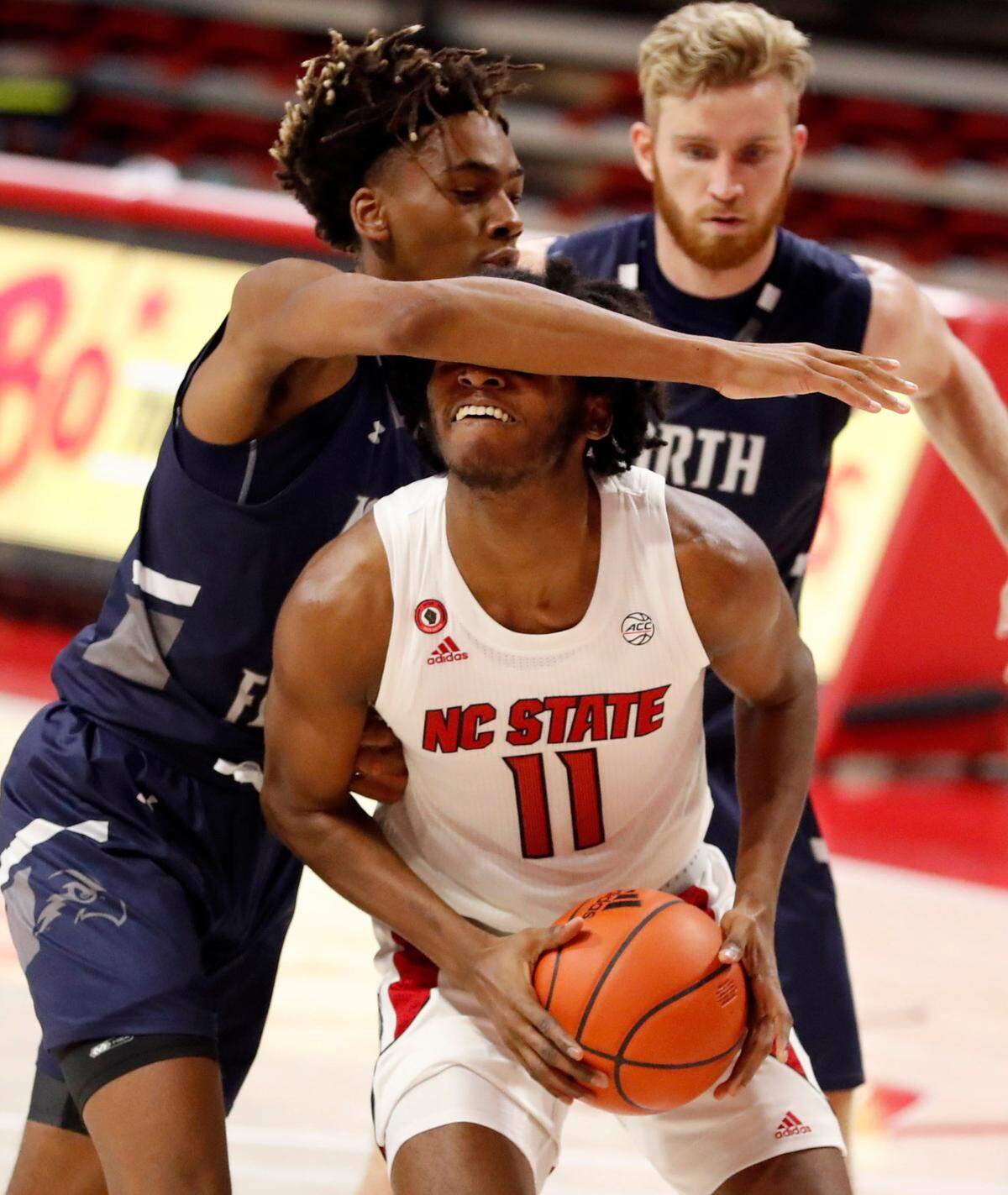 N.C. State’s Jaylon Gibson (11) prepares to shoot as North Florida’s Jadyn Parker (24) defends during the second half of N.C. State’s 86-51 victory over North Florida in the Mako Medical Wolfpack Invitational at Reynolds Coliseum in Raleigh, N.C., Friday, Nov. 27, 2020.