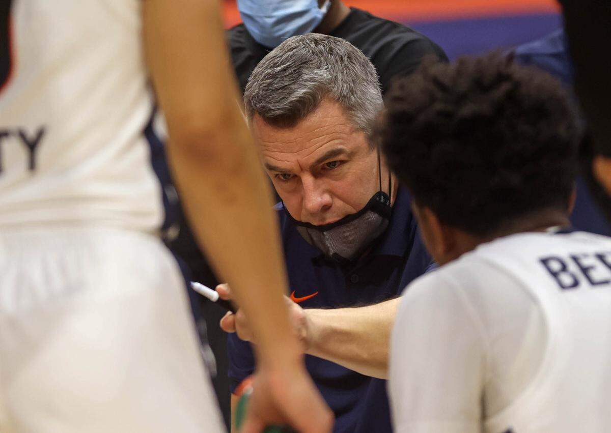 Virginia head coach Tony Bennett talks with his players in the huddle during the game against North Carolina State Wednesday in Charlottesville.