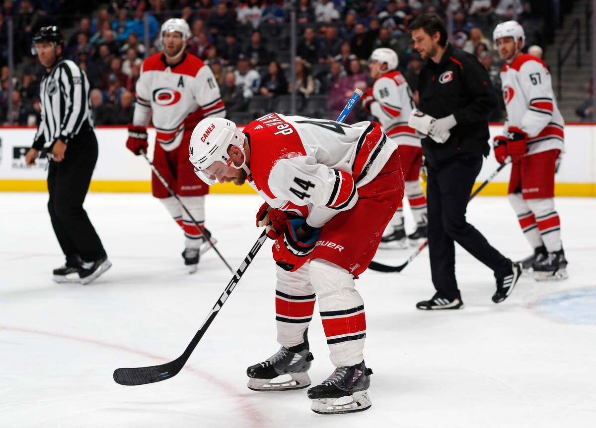 Carolina Hurricanes defenseman Calvin de Haan skates off the ice after being injured in the third period of an NHL hockey game against the Colorado Avalanche, Monday, March 11, 2019, in Denver. Carolina won 3-0. (AP Photo/David Zalubowski)