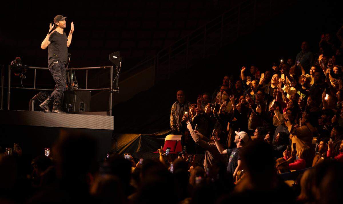 Enrique Iglesias works the crowd from a riser on “The Trilogy Tour” at Raleigh, N.C.’s PNC Arena, Thursday night, Feb. 29, 2024.