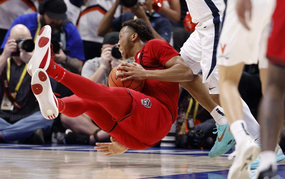 N.C. State's Quadir Copeland (11) falls to the ground after being fouled in the first half of N.C. State’s game against Virginia in the quarterfinals of the 2026 ACC Men’s Basketball Tournament at the Spectrum Center in Charlotte, N.C., Thursday, March 12, 2026.
