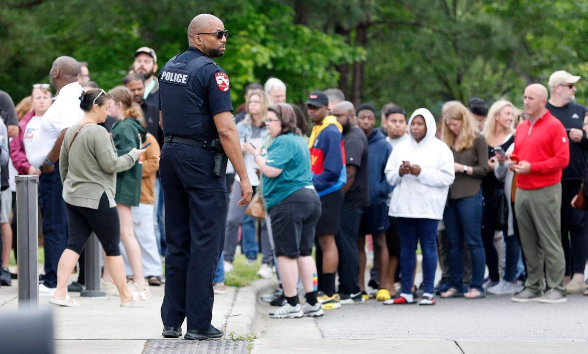 Parents line up at Middle Creek Community Library to check out their children from Middle Creek High School in Apex, N.C., on April 27, 2023 after a gun was reported on campus. New security rules are being proposed for when people visit Wake County school campuses.