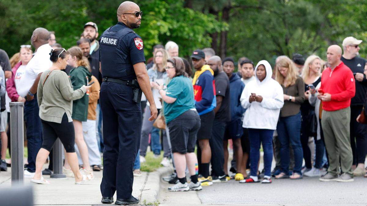 Parents line up at Middle Creek Community Library to check out their children from Middle Creek High School in Apex, N.C., on April 27, 2023 after a gun was reported on campus. New security rules are being proposed for when people visit Wake County school campuses.