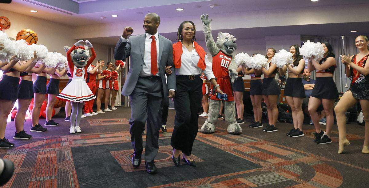 New N.C. State head men’s basketball coach Justin Gainey and his wife Courtney are celebrated as they walk into the room for a press conference at the Lenovo Center to officially announce Gainey as the head coach Wednesday, April 1, 2026.