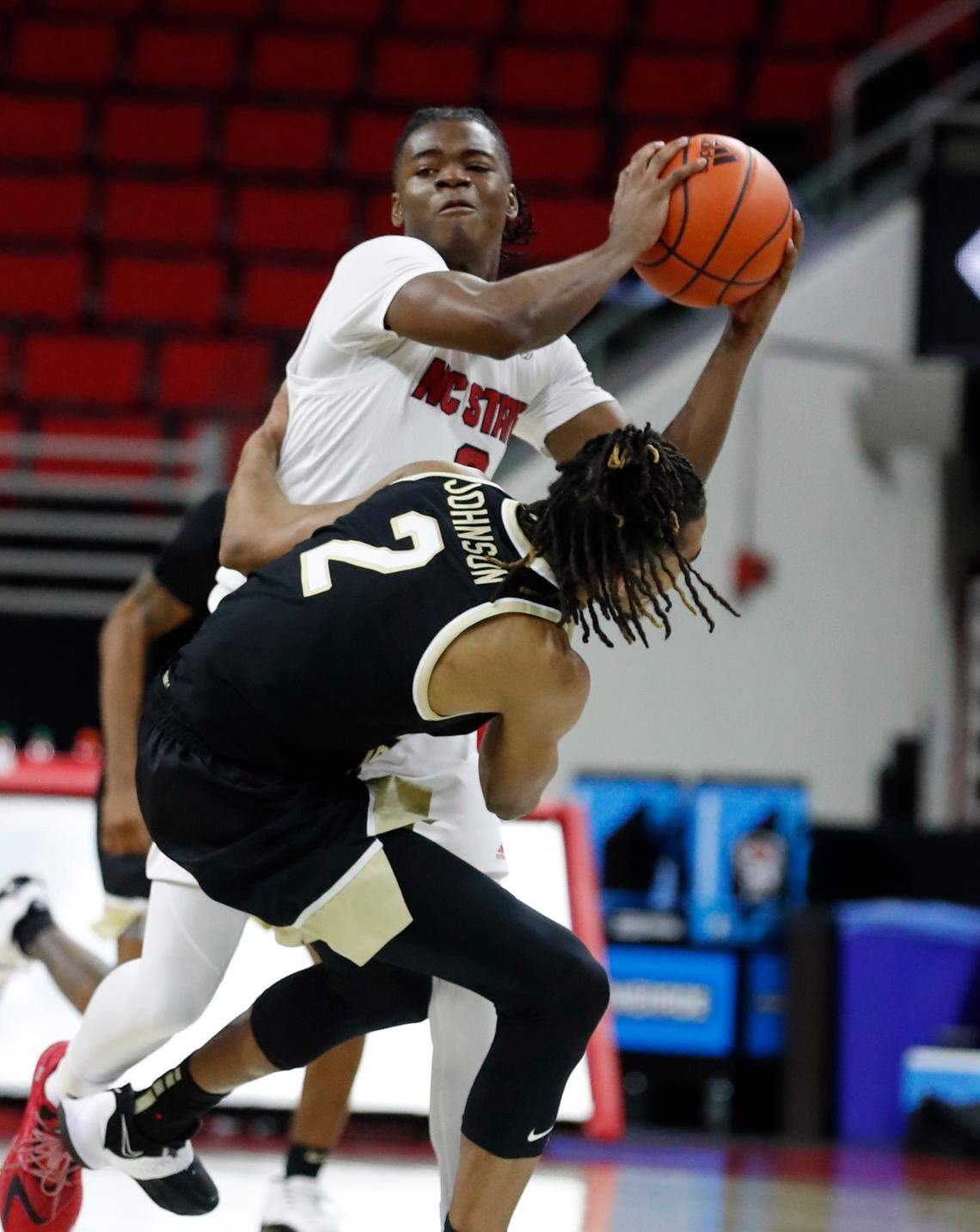 Wake Forest’s Jalen Johnson (2) fouls N.C. State’s Cam Hayes (3) during the second half of N.C. State’s 72-67 victory over Wake Forest at PNC Arena in Raleigh, N.C., Wednesday, January 27, 2021.