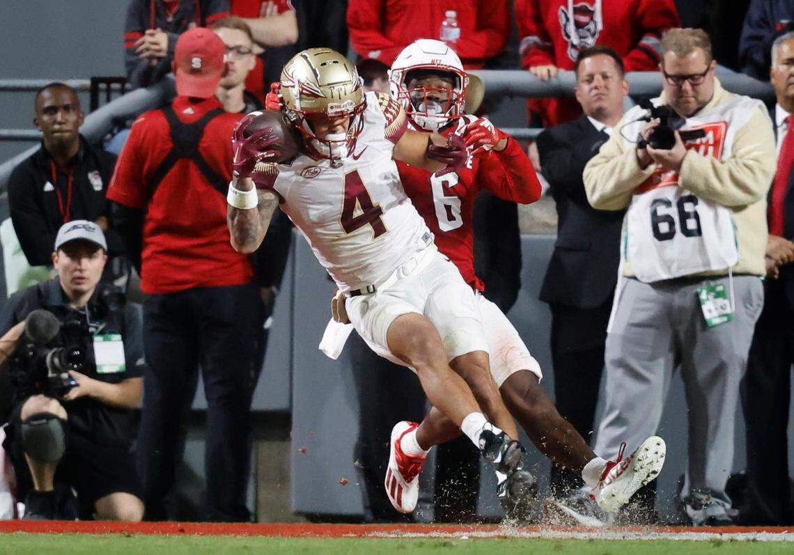 Florida State wide receiver Mycah Pittman (4) makes a 14-yard touchdown reception as N.C. State safety Jakeen Harris (6) defends during the first half of N.C. State’s game against Florida State at Carter-Finley Stadium in Raleigh, N.C., Saturday, Oct. 8, 2022.