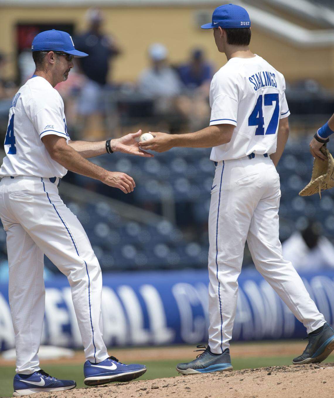 Duke coach Chris Pollard takes the ball from starting pitcher Mitch Stallings (47) as Stallings exits the game against Louisville during the ACC Championship on Friday, May 25, 2018 at Durham Bulls Athletic Park in Durham, N.C.