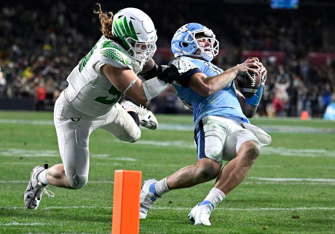 North Carolina quarterback Drake Maye (10) is tackled by Oregon defensive lineman Casey Rogers (98) during the second half of the Holiday Bowl NCAA college football game Wednesday, Dec. 28, 2022, in San Diego. (AP Photo/Denis Poroy)