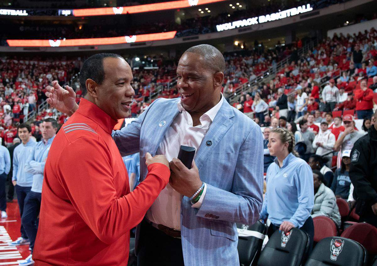 N.C. State head coach Kevin Keatts and North Carolina head coach Hubert Davis share a laugh prior to their game on Saturday, Jan. 11, 2025, at Lenovo Center in Raleigh, N.C.