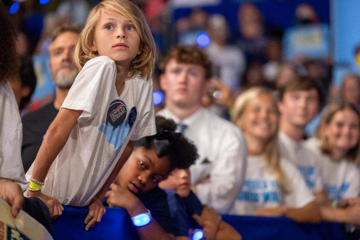 Children line the front row to catch a glimpse of Vice President Kamala Harris during a rally at Minges Coliseum on Sunday, October 13, 2024 in Greenville, N.C.