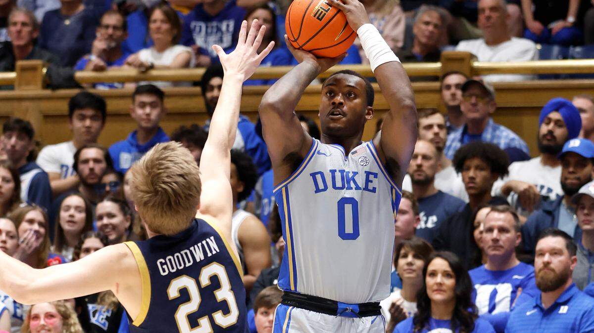 Duke’s Dariq Whitehead (0) hits a three-pointer as Notre Dame’s Dane Goodwin (23) defends during the first half of Duke’s game against Notre Dame at Cameron Indoor Stadium in Durham, N.C., Tuesday, Feb. 14, 2023.