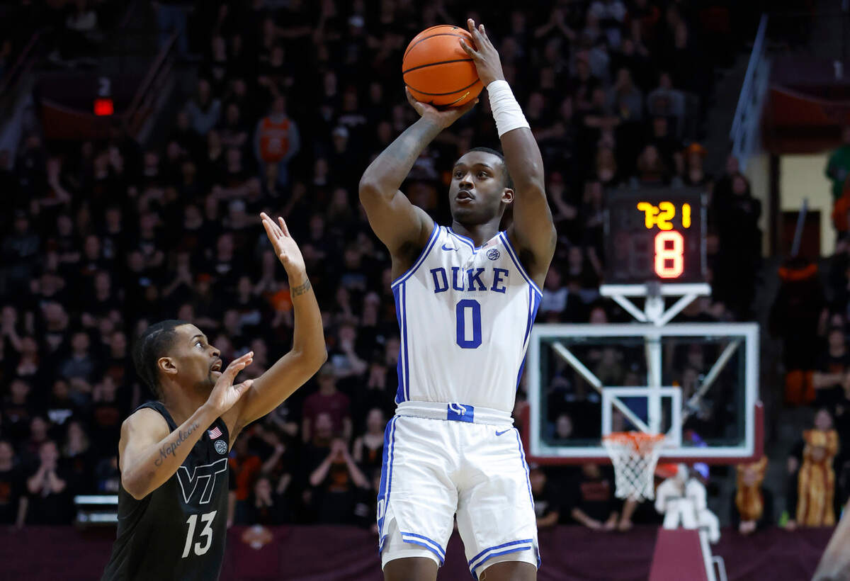 Duke’s Dariq Whitehead (0) shoots as Virginia Tech’s Darius Maddox (13) defends during the first half of Duke’s game against Virginia Tech at Cassell Coliseum in Blacksburg, VA., Monday, Jan. 23, 2023.