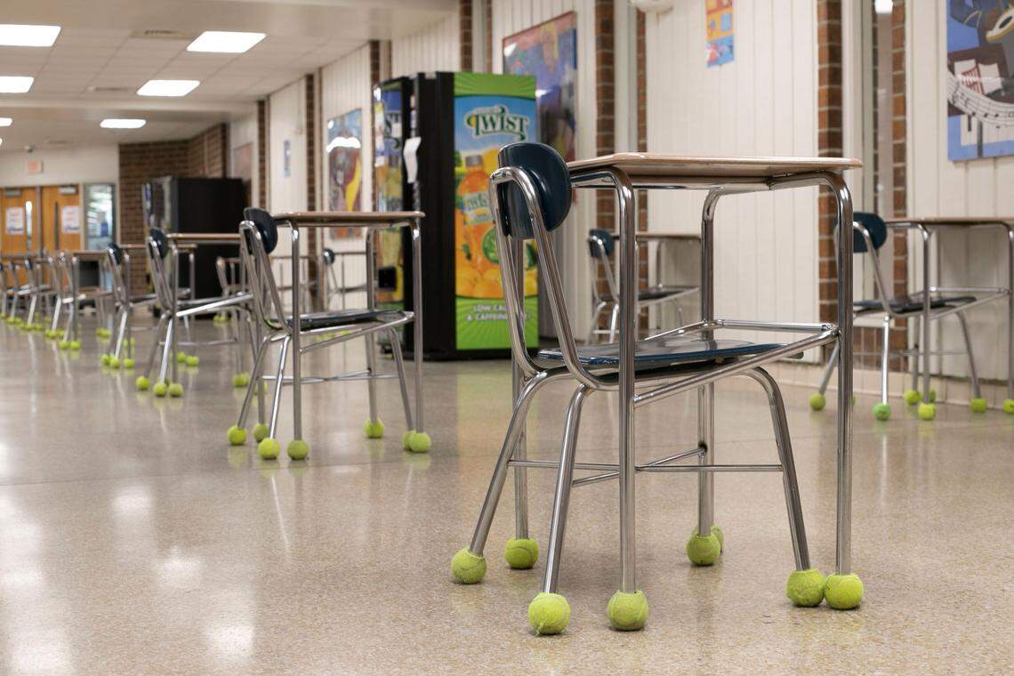 Tables and chairs are lined up, spaced out and facing in the same direction in the lunchroom of Athens Drive Magnet High School on Wednesday, February 10, 2020 in Raleigh, N.C. as they prepare to welcome back students for in-person classes next week. The number of people in the lunchroom will be limited and timed to prevent the possible spread of the COVID-19 virus.