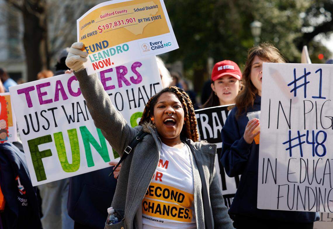 Amanda Bizune from Apex, center, cheers during a rally for education funding on the grounds of the N.C. State Capitol in Raleigh Thursday, Feb. 22, 2024. The rally happened as the state Supreme Court heard oral arguments in the long-running Leandro school funding case.