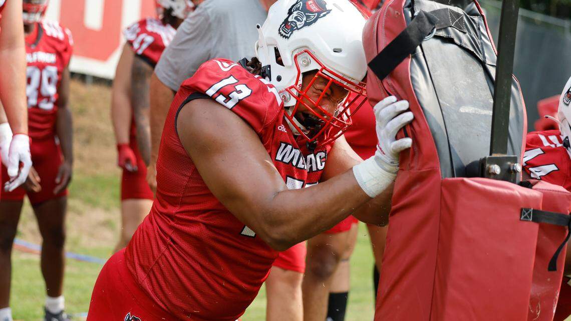N.C. State defensive end Travali Price (13) attacks the pads during the Wolfpack’s first fall practice in Raleigh, N.C., Wednesday, August 2, 2023.