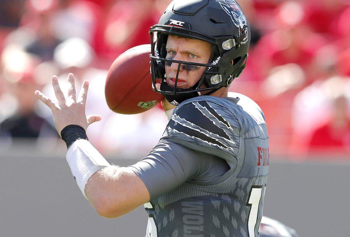 N.C. State quarterback Ryan Finley (15) passes during the Wolfpakc’s 33-25 victory over Syracuse at Carter-Finley Stadium Saturday, Sept. 30, 2017.