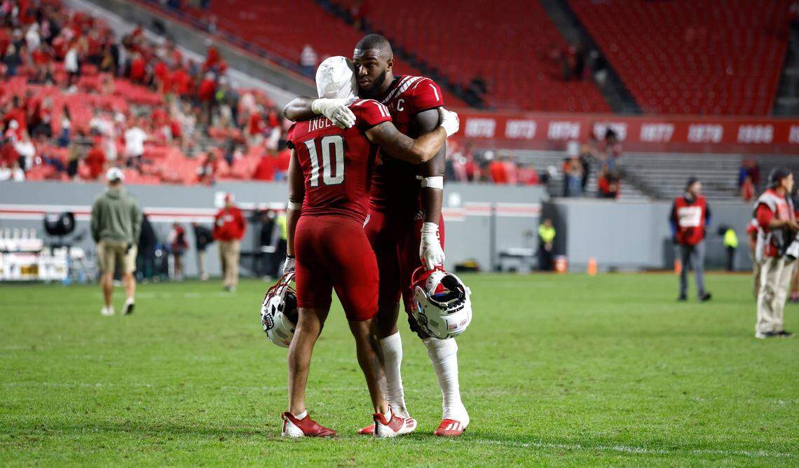 N.C. State linebacker Isaiah Moore (1) and safety Tanner Ingle (10) hug after Boston College’s 21-20 victory over N.C. State at Carter-Finley Stadium in Raleigh, N.C., Saturday, Nov. 12, 2022.