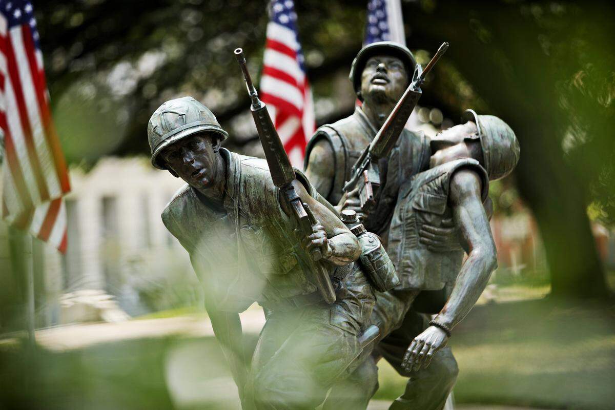 The North Carolina Vietnam Veterans Memorial was dedicated on May 23, 1987. The monument features three soldiers in a scene called ÒAfter the Firefight.Ó Two soldiers carry a fellow wounded soldier. According to the state, it honors the more than 206,000 men and women from North Carolina who served in the Vietnam War.