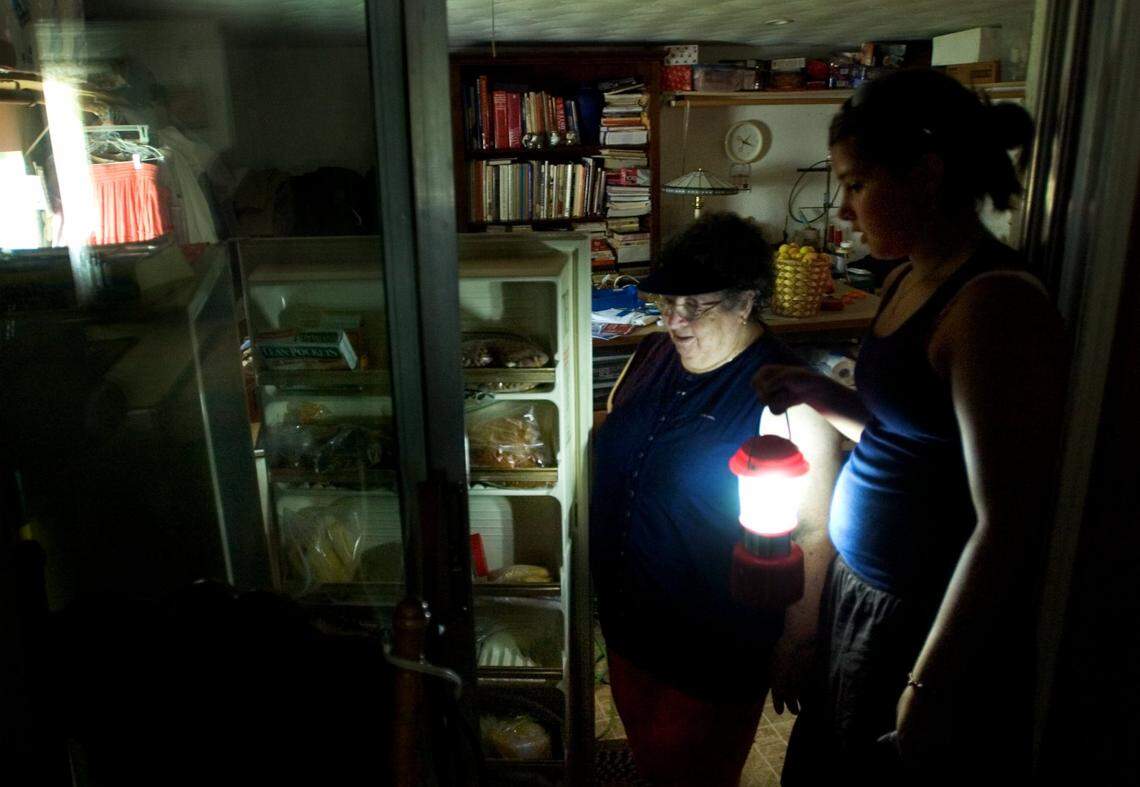 A Sacramento family without power for three days checks food in the freezer after their gas generator runs out fuel. SACRAMENTO BEE