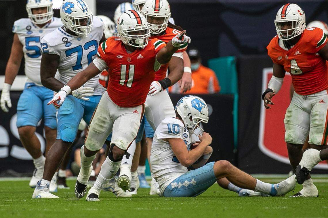 Miami’s Corey Flagg Jr. (11) reacts after sacking North Carolina quarterback Drake Maye (10) for a loss in the third quarter on Saturday, October 8, 2022 at Hard Rock Stadium in Miami Gardens, Florida.