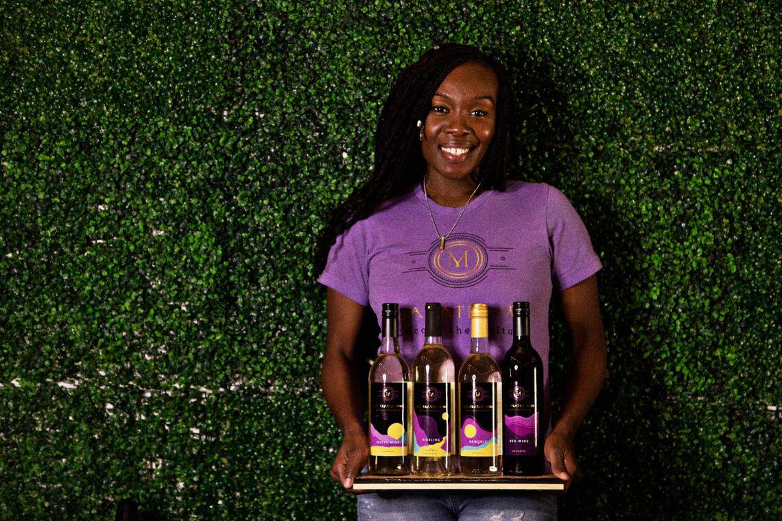 Melanated Wine founder LaShonda Fort-Modest with the company’s four wines in their Durham tasting room on Thursday, Feb. 10, 2022. Fort-Modest believes that the minority community had been overlooked in the area of wine which led her to learn more about the industry and open Melanated Wine last year.