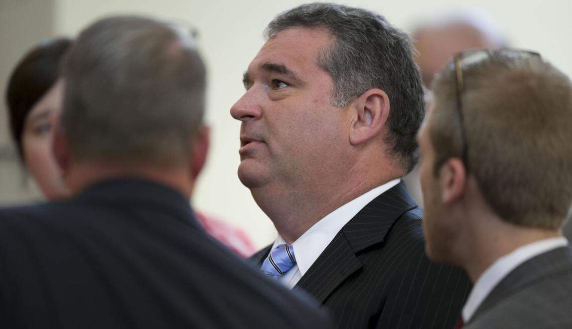 Rep. David R. Lewis, center, confers with House Speaker Tim Moore and fellow legislators and staff during the first extra session of the Legislature on Tuesday, July 24, 2018 in Raleigh, N.C. Lawmakers were called back to Raleigh to write captions for constitutional amendments for the November election ranging from voter ID, income tax, judicial vacancies and governor's power. Lewis is the sponsor of the legislation.