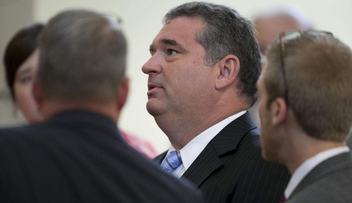 Rep. David R. Lewis, center, confers with House Speaker Tim Moore and fellow legislators and staff during the first extra session of the Legislature on Tuesday, July 24, 2018 in Raleigh, N.C. Lawmakers were called back to Raleigh to write captions for constitutional amendments for the November election ranging from voter ID, income tax, judicial vacancies and governor's power. Lewis is the sponsor of the legislation.