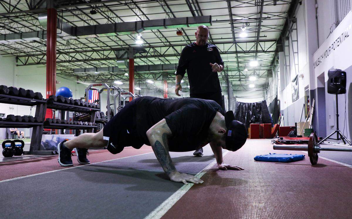 Head strength and conditioning coach for the Carolina Hurricanes, Bill Burniston, coaches goalie Scott Darling through an intense workout at The Performance Academy on Monday July 2, 2018.