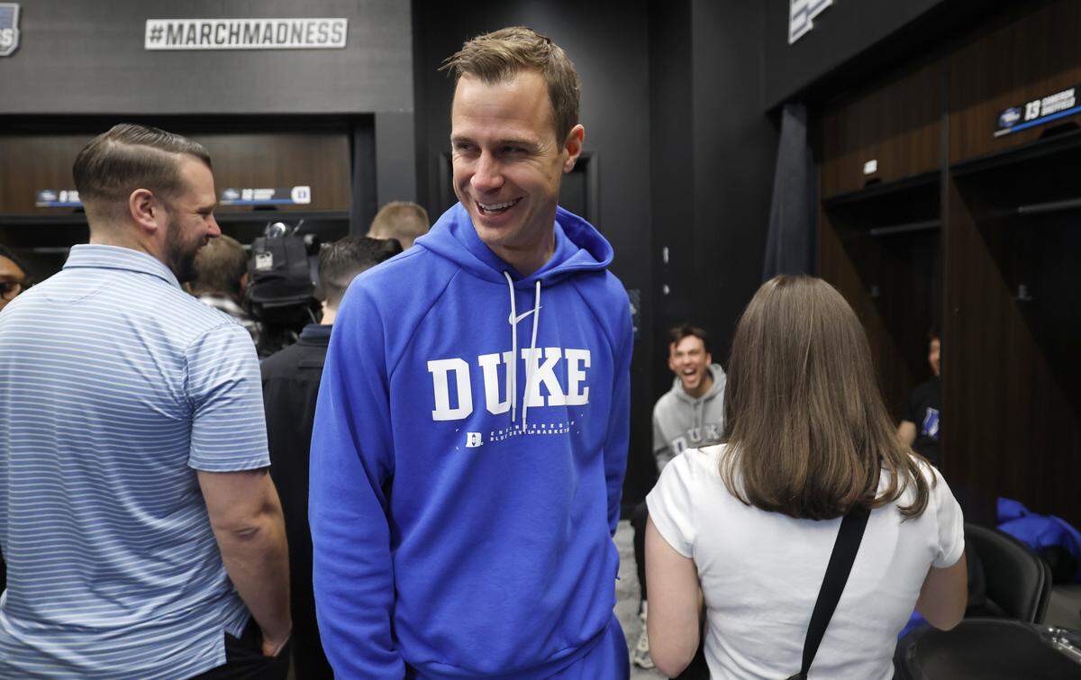 Duke’s Jon Scheyer laughs as he walks through the locker room before the Blue Devils’ practice at Capital One Arena in Washington, D.C., Thursday, March 26, 2026. The Blue Devils face St. John’s in the Sweet 16 of the NCAA Men’s Basketball East Regional Friday.