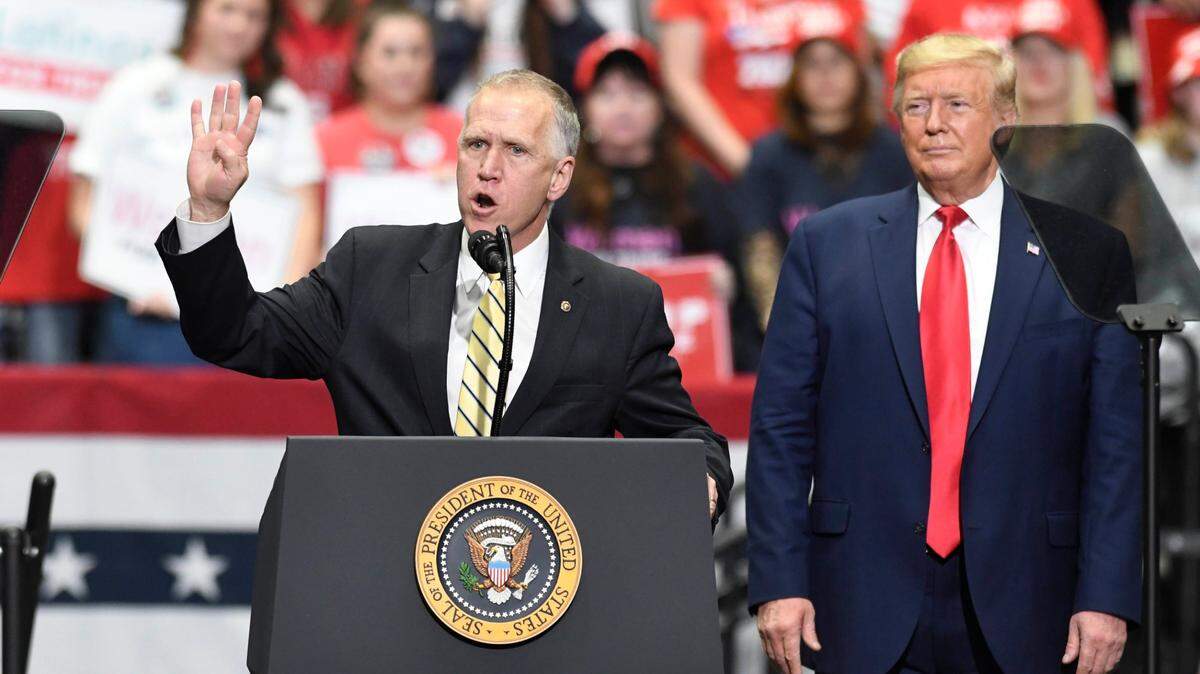 President Donald J. Trump listens as U.S. Senator Thom Tillis of North Carolina addresses supporters during a rally at Bojangles Arena in Charlotte, in March 2020