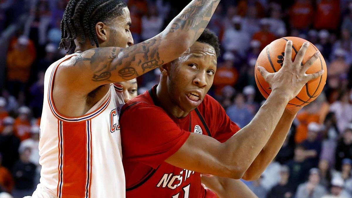 N.C. State's Quadir Copeland (11) drives by Clemson's Dillon Hunter (2) during the first half of N.C. State’s game against Clemson at Littlejohn Coliseum in Clemson, S.C., Tuesday, Jan. 20, 2026.