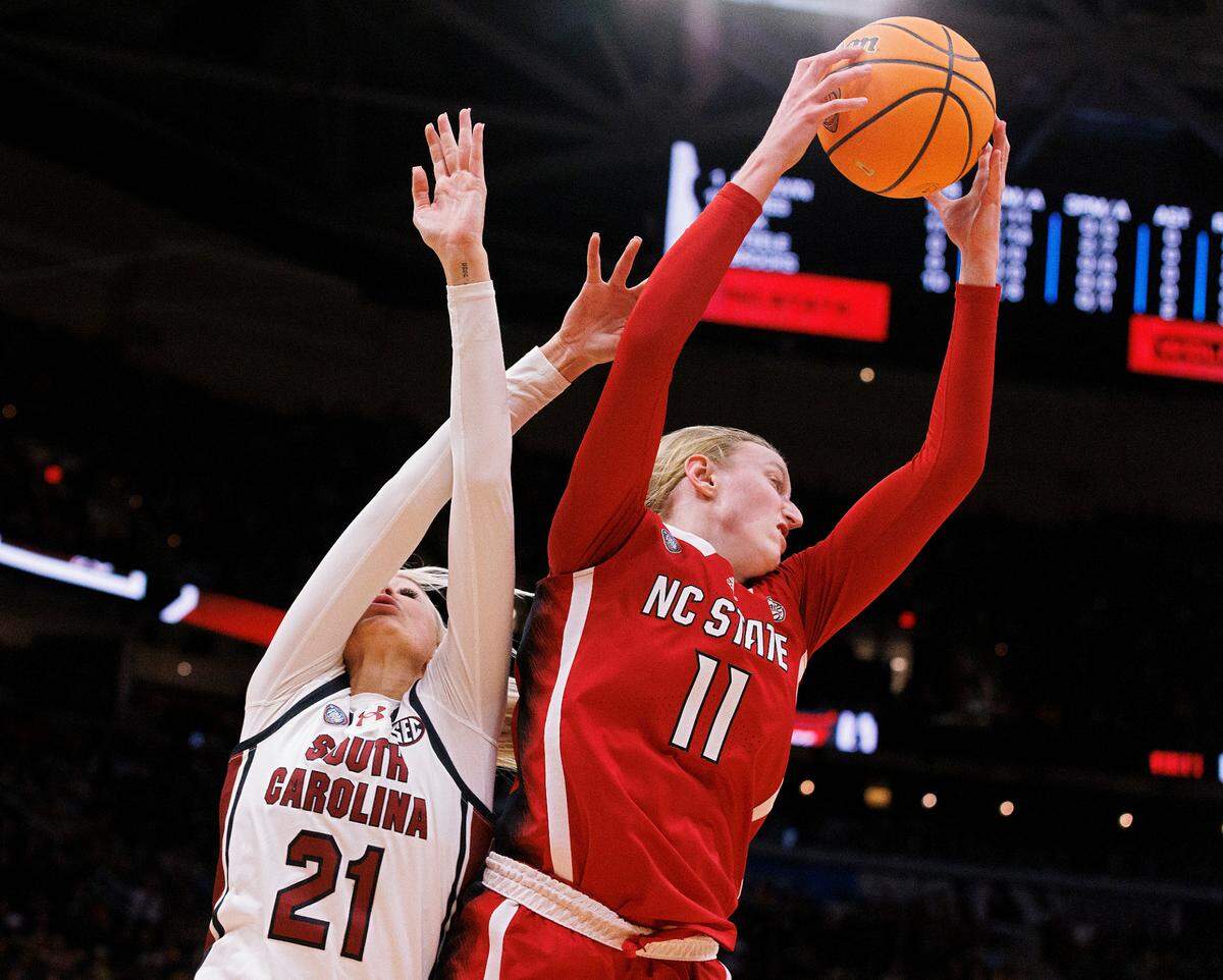 N.C. State’s Maddie Cox pulls down a rebound away from South Carolina’s Chloe Kitts during the second half of the Wolfpack’s 78-59 Final Four loss at Rocket Mortgage FieldHouse on Friday, April 5, 2024, in Cleveland, Ohio.