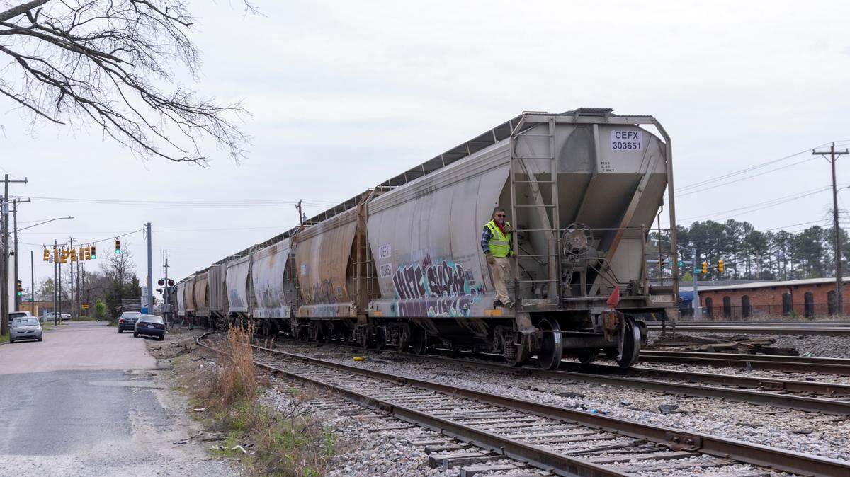 A train travels along the tracks near the rail crossing on Driver Street in East Durham on March 22, 2024. A man was struck by a freight train nearby early Tuesday morning.