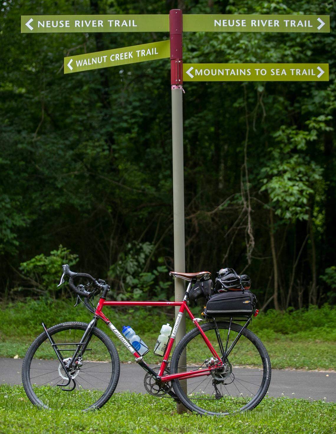 Directional signage at the intersection with the Walnut Creek Trail and Neuse River Trail, part of the East Coast Greenway system on Tuesday, June 15, 2021 in Raleigh, N.C. Legislation is being introduced to add the East Coast Greenway to the North Carolina State Parks system.