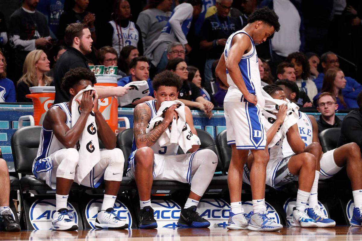 From left, Duke’s AJ Griffin (21), Paolo Banchero (5), Jeremy Roach (3), Trevor Keels (1) and Mark Williams (15) sit on the bench in the final minute of Virginia Tech’s 82-67 victory over Duke in the finals of the ACC men’s basketball tournament at the Barclays Center in Brooklyn, N.Y., Saturday, March 12, 2022.