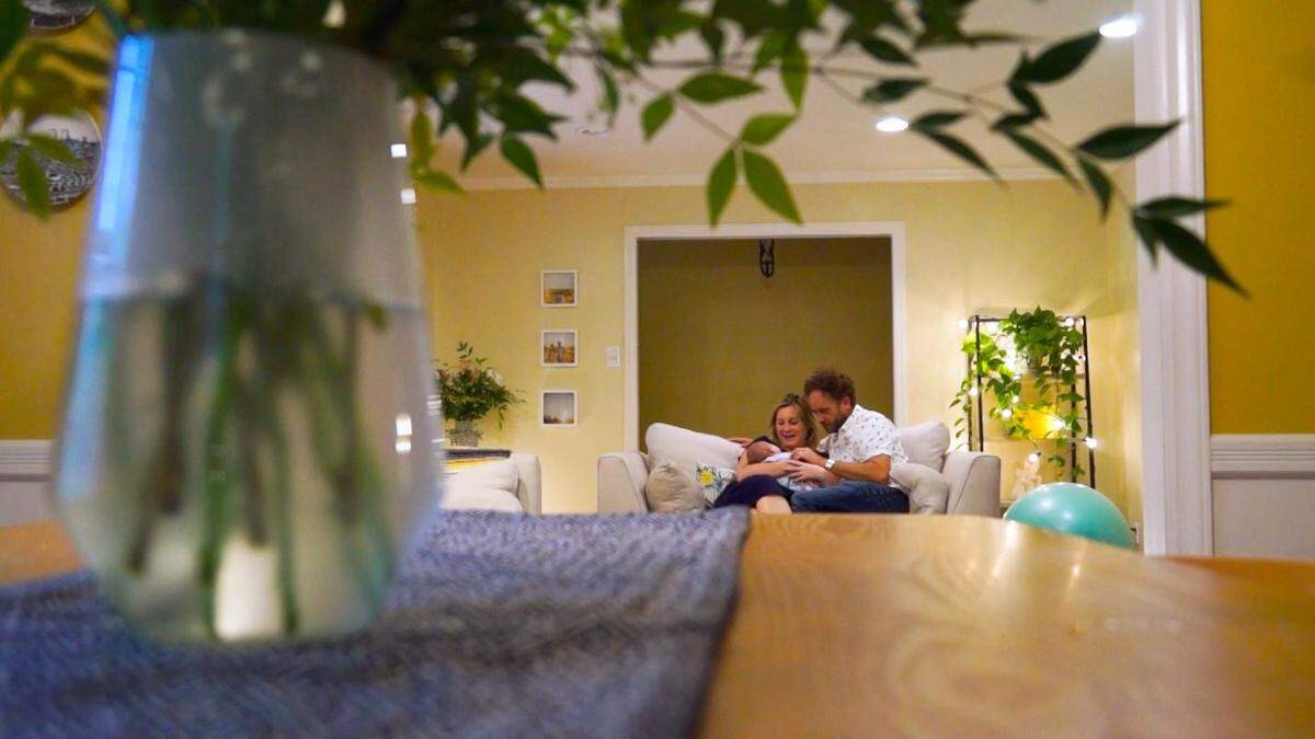 Peter Norton and his wife, Jennifer, holding their newborn baby, Mackinnon, in their Durham home. Peter Norton is originally from South Africa.