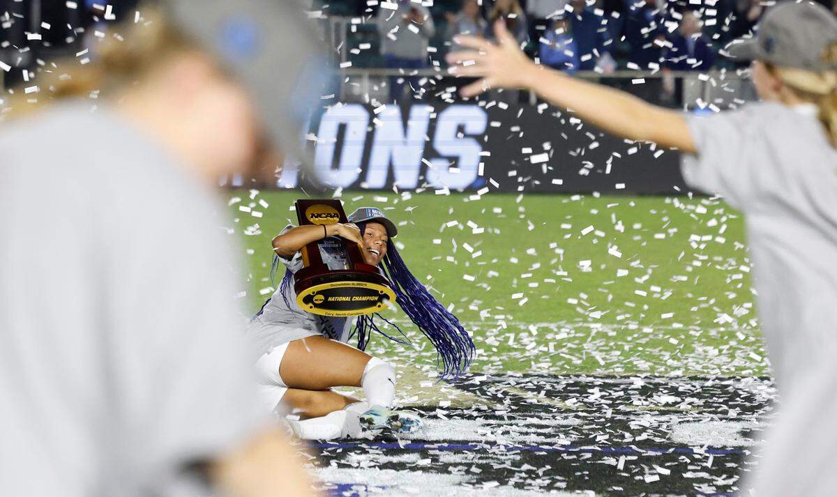North Carolina’s Olivia Thomas (33) celebrates with the trophy after UNC’s 1-0 victory over Wake Forest in the finals of the 2024 Women’s College Cup at WakeMed Soccer Park in Cary, N.C., Monday, Dec. 9, 2024.