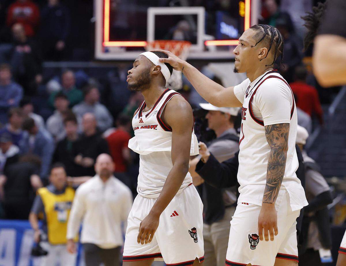 N.C. State’s Tre Holloman and Darrion Williams walk off the court following the Wolfpack’s 68-66 loss to Texas in the NCAA First Four on Tuesday, March 17, 2026, at the University of Dayton Arena in Dayton, Ohio.
