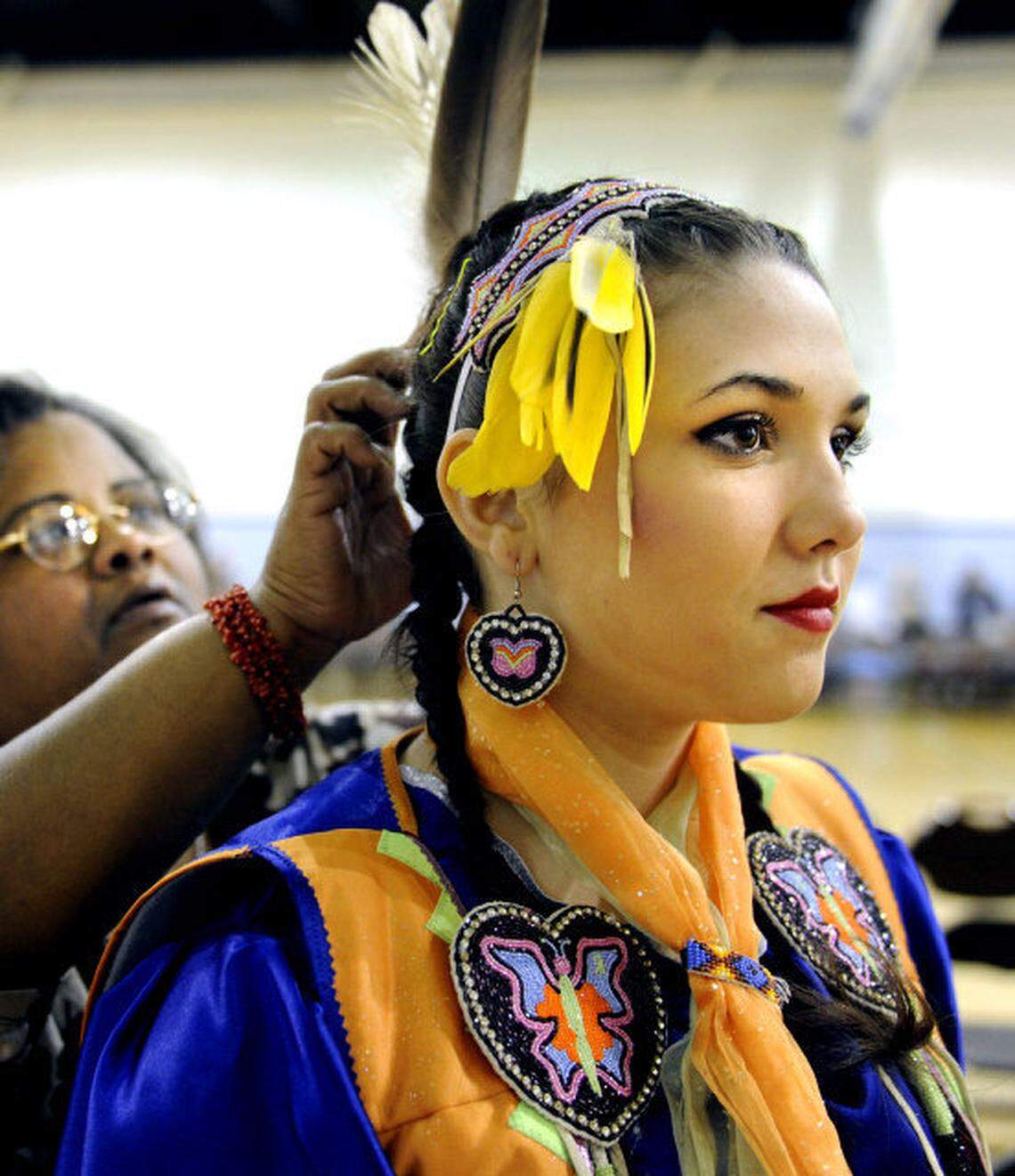 Raven Stanley, right, of Greensboro and the Lumbee tribe gets help preparing for the Carolina Indian Circle Powwow from Tabitha Jacobs, left, at UNC-Chapel Hill Saturday March 23, 2013, in Chapel Hill.