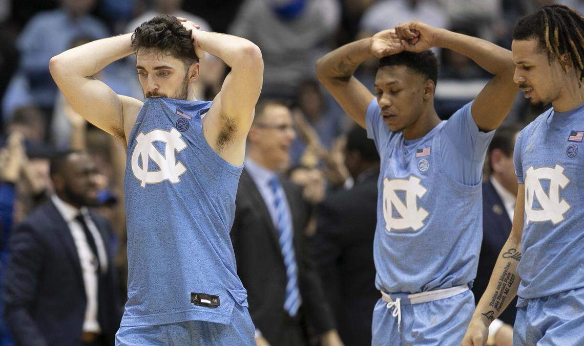 North Carolina’s Andrew Platek (3), Christian Keeling (55) and Cole Anthony (2) leave the court dejected after Duke defeated the Tar Heels’ 98-96 in overtime on Saturday, February 8, 2020 at the Smith Center in Chapel Hill, N.C.