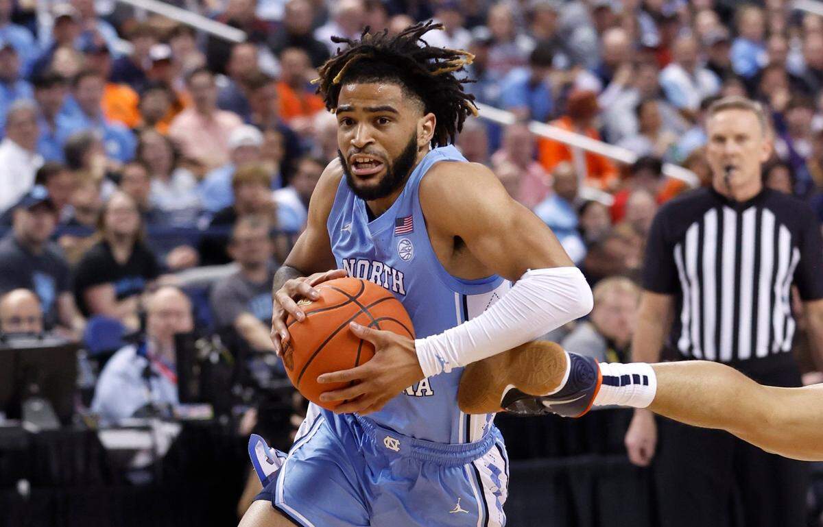 North Carolina’s RJ Davis (4) drives to the basket during the first half of UNC’s game against Virginia in the quarterfinals of the ACC Men’s Basketball Tournament in Greensboro, N.C., Thursday, March 9, 2023.