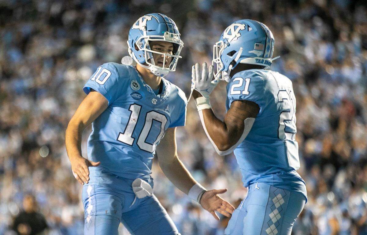 North Carolina quarterback Drake Maye congratulates Elijah Green (21) after Green’s game winning touchdown on a two yard run to give the Tar Heels’ 28-24 lead in the fourth quarter against Pitt on Saturday, October 29, 2022 at Kenan Stadium in Chapel Hill, N.C.